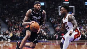 Toronto Raptors' Brandon Ingram (3) drives around Miami Heat's Davion Mitchell (45) during first half NBA basketball action in Toronto on Thursday, April 9, 2026. (Nathan Denette/CP)