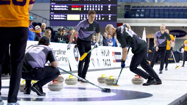 Italy's Amos Mosaner sweeps a rock thrown by Canadian skip Brad Jacobs for Team Shield in this handout photo, during a Rock League curling game against Team Alpine at Toronto's Mattamy Athletic Centre, on Monday, April 6, 2026. (Anil Mungal/The Curling Group via CP)