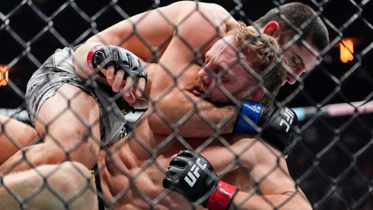 Jack Della Maddalena grapples with Islam Makhachev during the first round of their welterweight title bout at UFC 322 in New York. (Yuki Iwamura/AP)
