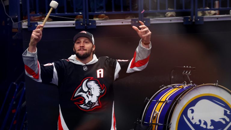 Buffalo Bills quarterback Josh Allen hypes the crowd prior to the first period in Game 2 of a first-round NHL hockey Stanley Cup playoff series between the Buffalo Sabres and Boston Bruins Tuesday, April 21, 2026, in Buffalo, N.Y. (Jeffrey T. Barnes/AP)