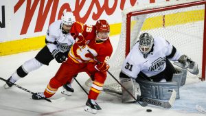 Los Angeles Kings goalie Anton Forsberg, right, blocks the net on Calgary Flames' Victor Olofsson, centre, as Scott Laughton checks during third period NHL hockey action in Calgary on Thursday, April 16, 2026. (Jeff McIntosh/CP)