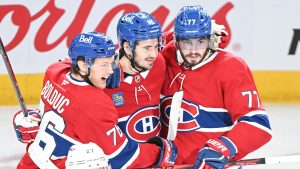 Kirby Dach (77) celebrates with teammates Zachary Bolduc (76) and Alexandre Texier (85) after scoring against the Tampa Bay Lightning during second period NHL playoff action in Montreal, Friday, April 24, 2026. (Graham Hughes/CP)