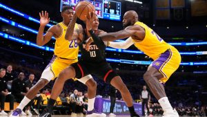 Houston Rockets forward Jabari Smith Jr., center, tries to pass while under pressure from Los Angeles Lakers forward Rui Hachimura, left, and forward LeBron James during the first half in Game 1 of a first-round NBA playoffs basketball series Saturday, April 18, 2026, in Los Angeles. (Mark J. Terrill/AP)