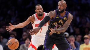 Los Angeles Lakers forward LeBron James, right, passes the ball while under pressure from Houston Rockets forward Kevin Durant during the first half in Game 2 of a first-round NBA playoffs basketball series Tuesday, April 21, 2026, in Los Angeles. (AP Photo/Mark J. Terrill)