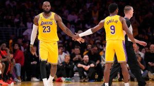 Los Angeles Lakers forward LeBron James, left, slaps hands with guard Bronny James during the first half in Game 1 of a first-round NBA playoffs basketball series against the Houston Rockets, Saturday, April 18, 2026, in Los Angeles. (Mark J. Terrill/AP)