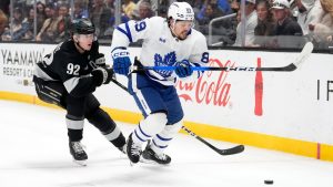 Los Angeles Kings defenceman Brandt Clarke, left, and Toronto Maple Leafs left wing Nicholas Robertson go after the puck during the first period of an NHL hockey game Saturday, April 4, 2026, in Los Angeles. (AP Photo/Mark J. Terrill)
