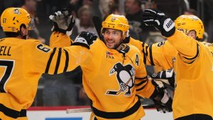 Pittsburgh Penguins' Kris Letang (58) celebrates with Rickard Rakell, left, after scoring during the second period of Game 5 in the first round of the NHL Stanley Cup playoffs against the Philadelphia Flyers in Pittsburgh, Monday, April 27, 2026. (Gene J. Puskar/AP)