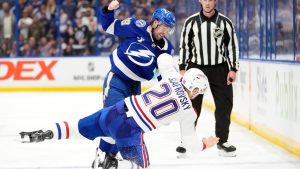 Tampa Bay Lightning left wing Brandon Hagel (38) kncosk down MontrÃ©al Canadiens left wing Juraj SlafkovskÃ½ (20) as they fight during the second period in Game 2 of an NHL hockey Stanley Cup first-round playoff series, Tuesday, April 21, 2026, in Tampa, Fla. (Chris O'Meara/AP)