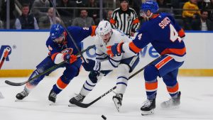 New York Islanders' Carson Soucy (4) and Scott Mayfield (24) defend Toronto Maple Leafs' Steven Lorentz (18) during the third period of an NHL hockey game Thursday, April 9, 2026, in Elmont, N.Y. (Frank Franklin II/AP)