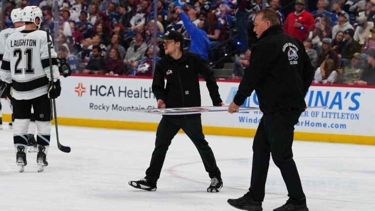 Members of the Colorado Avalanche conversion crew carry a new piece of glass to the Los Angeles Kings' bench during the second period of Game 2 in the first round of the NHL hockey Stanley Cup playoffs against the Colorado Avalanche, Tuesday, April 21, 2026, in Denver. (Jack Dempsey/AP)