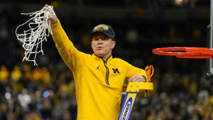 Michigan head coach Dusty May celebrates by cutting down the net after defeating UConn in the NCAA college basketball tournament national championship game at the Final Four, Monday, April 6, 2026, in Indianapolis. (Michael Conroy/AP)