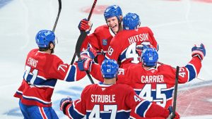 Montreal Canadiens' Lane Hutson (48) celebrates with teammate Kaiden Kuhle (21), Jake Evans (71), Jayden Struble (47) and Alexandre Carrier (45) after scoring against the Tampa Bay Lightning during overtime period NHL playoff hockey action in Montreal, Friday, April 24, 2026. (Graham Hughes/CP)
