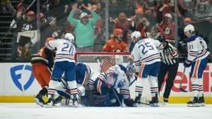 Anaheim Ducks left wing Chris Kreider, top center, reacts on the game-winning, overtime goal by center Ryan Poehling, not shown, in Game 4 in the first round of an NHL hockey Stanley Cup playoff series against the Edmonton Oilers, Sunday, April 26, 2026, in Anaheim, Calif. (AP Photo/Kyusung Gong)