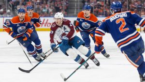 Colorado Avalanche's Nathan MacKinnon (29) is surrounded by Edmonton Oilers' Connor McDavid (97), Matt Savoie (22), Vasily Podkolzin (92) and Evan Bouchard (2) during first period NHL action, in Edmonton on Monday, April 13, 2026. (Jason Franson/CP)