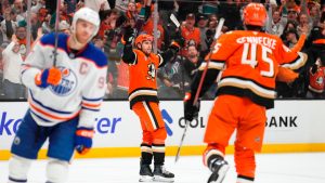Anaheim Ducks left wing Cutter Gauthier, centre, celebrates his goal with right wing Beckett Sennecke, right, as Edmonton Oilers centre Connor McDavid skates by during the first period of Game 6 in the first round of the NHL hockey Stanley Cup playoffs series Thursday, April 30, 2026, in Anaheim, Calif. (Mark J. Terrill/AP)