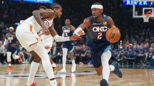 Oklahoma City Thunder guard Shai Gilgeous-Alexander, right, drives past Phoenix Suns guard Jalen Green during the second half in Game 2 of a first-round NBA playoffs basketball series Wednesay, April 22, 2026, in Oklahoma City. (Kyle Phillips/AP)