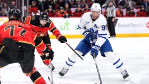 Ottawa Senators' Drake Batherson (19) tries to take the puck from Toronto Maple Leafs' John Tavares (91) during first period NHL hockey action in Ottawa, on Saturday, March 21, 2026. (Justin Tang/CP)