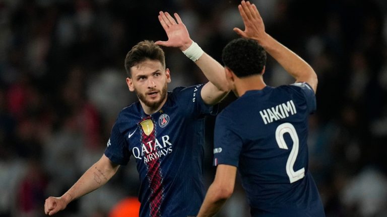 PSG's Khvicha Kvaratskhelia, left, celebrates after scoring his side's fourth goal during the Champions League semifinal first leg soccer match between Paris Saint-Germain and Bayern Munich in Paris, Tuesday, April 28, 2026. (AP Photo/Christophe Ena)