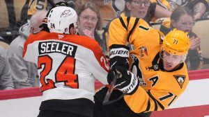 Pittsburgh Penguins' Evgeni Malkin (71) is defended by Philadelphia Flyers' Nick Seeler during the first period of Game 1 in the first round of the NHL Stanley Cup playoffs in Pittsburgh, Saturday, April 18, 2026. (Gene J. Puskar/AP)