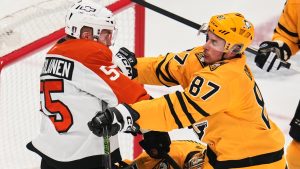 Pittsburgh Penguins' Sidney Crosby (87) checks Philadelphia Flyers' Rasmus Ristolainen (55) in front of Penguins goalie Stuart Skinner, center bottom, during the first period of Game 2 in the first round of the NHL Stanley Cup playoffs in Pittsburgh, Monday, April 20, 2026. (AP Photo/Gene J. Puskar)