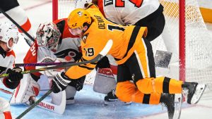Philadelphia Flyers goaltender Dan Vladar (80) blocks shot with teammate Owen Tippett (74) defending against Pittsburgh Penguins' Connor Dewar (19) during the first period of Game 5 in the first round of an NHL hockey Stanley Cup playoff series in Pittsburgh, Monday, April 27, 2026. (Gene J. Puskar/AP)