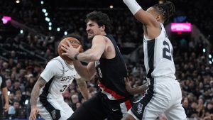 Portland Trail Blazers forward Deni Avdija (8) drives past San Antonio Spurs guard Devin Vassell (24) during the first half in Game 2 of a first-round NBA playoffs basketball series in San Antonio, Tuesday, April 21, 2026. (Eric Gay/AP)