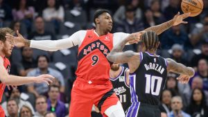 Toronto Raptors guard RJ Barrett (9) reaches for a rebound over Sacramento Kings forward DeMar DeRozan (10) during the first half of an NBA basketball game in Sacramento, Calif., Wednesday, Nov. 6, 2024. (Randall Benton/AP)