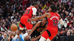 Cleveland Cavaliers centre Evan Mobley (4) makes a pass under pressure from Toronto Raptors guard Jamal Shead (23) and teammate forward Collin Murray-Boyles (12)during first half NBA playoff basketball action in Toronto on Sunday, April 26, 2026. (Frank Gunn/CP)