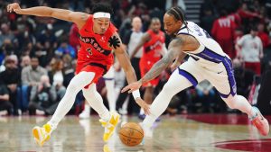 Toronto Raptors' Scottie Barnes (4) and Sacramento Kings' DeMar DeRozan (10) battle for the ball during first half NBA basketball action in Toronto on Wednesday, April 1, 2026. (Frank Gunn/CP)