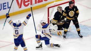Buffalo Sabres' Josh Doan (91) celebrates his goal with Zach Benson (6) beside Boston Bruins' Jeremy Swayman (1) and Charlie McAvoy (73) during the first period in Game 4 of a first-round NHL hockey Stanley Cup playoff series. (Michael Dwyer/AP)