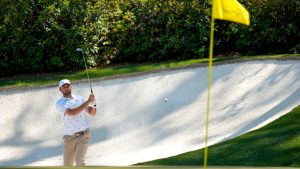 Scottie Scheffler hits from the bunker on the 12th hole during the third round of the Masters golf tournament at the Augusta National Golf Club, Saturday, April 11, 2026, in Augusta, Ga. (AP Photo/Ashley Landis)