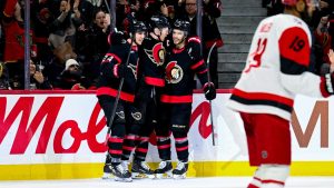 Ottawa Senators' Brady Tkachuk (7), centre, celebrates his goal on Carolina Hurricanes goaltender Frederik Andersen (31), not pictured, with teammate Ottawa Senators' Dylan Cozens (24), left, and Artem Zub (2) during second period NHL hockey action in Ottawa, on Sunday, April 5, 2026. (Spencer Colby/CP)