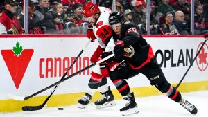 Carolina Hurricanes' Nicolas Deslauriers (44) tries to hold up Ottawa Senators' Fabian Zetterlund (20) as they fight for control of the puck during first period NHL hockey action in Ottawa, on Sunday, April 5, 2026. (Spencer Colby/CP)