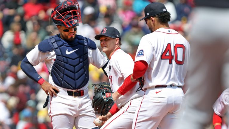Boston Red Sox' startng pitcher Sonny Gray, center, is visited on the mound by teammates Carlos Narvaez, left, and Willson Contreras after appearing to injure himself in the third inning during a baseball game against the Detroit Tigers, Monday, April 20, 2026 in Boston. He would leave the game with the injury. (AP Photo/Jim Davis)