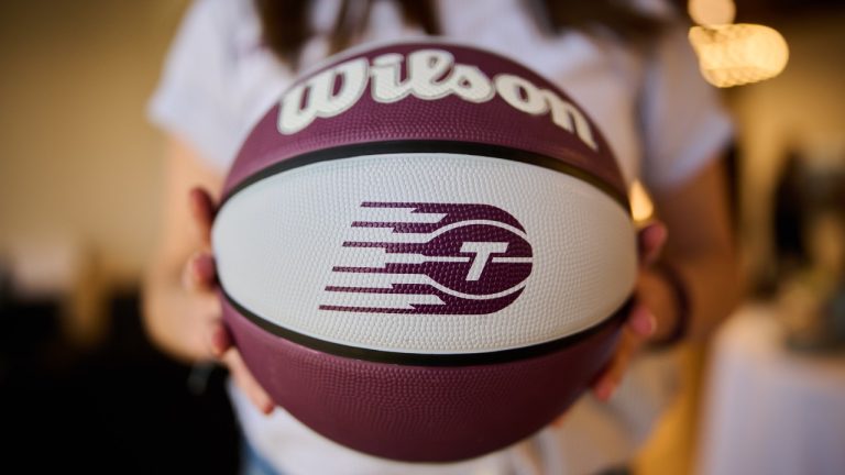 A Toronto Tempo logo on a basketball is shown as members of the media watch a broadcast of the WNBA Expansion Draft in Toronto, on Friday, April 3, 2026. (Sammy Kogan/CP)
