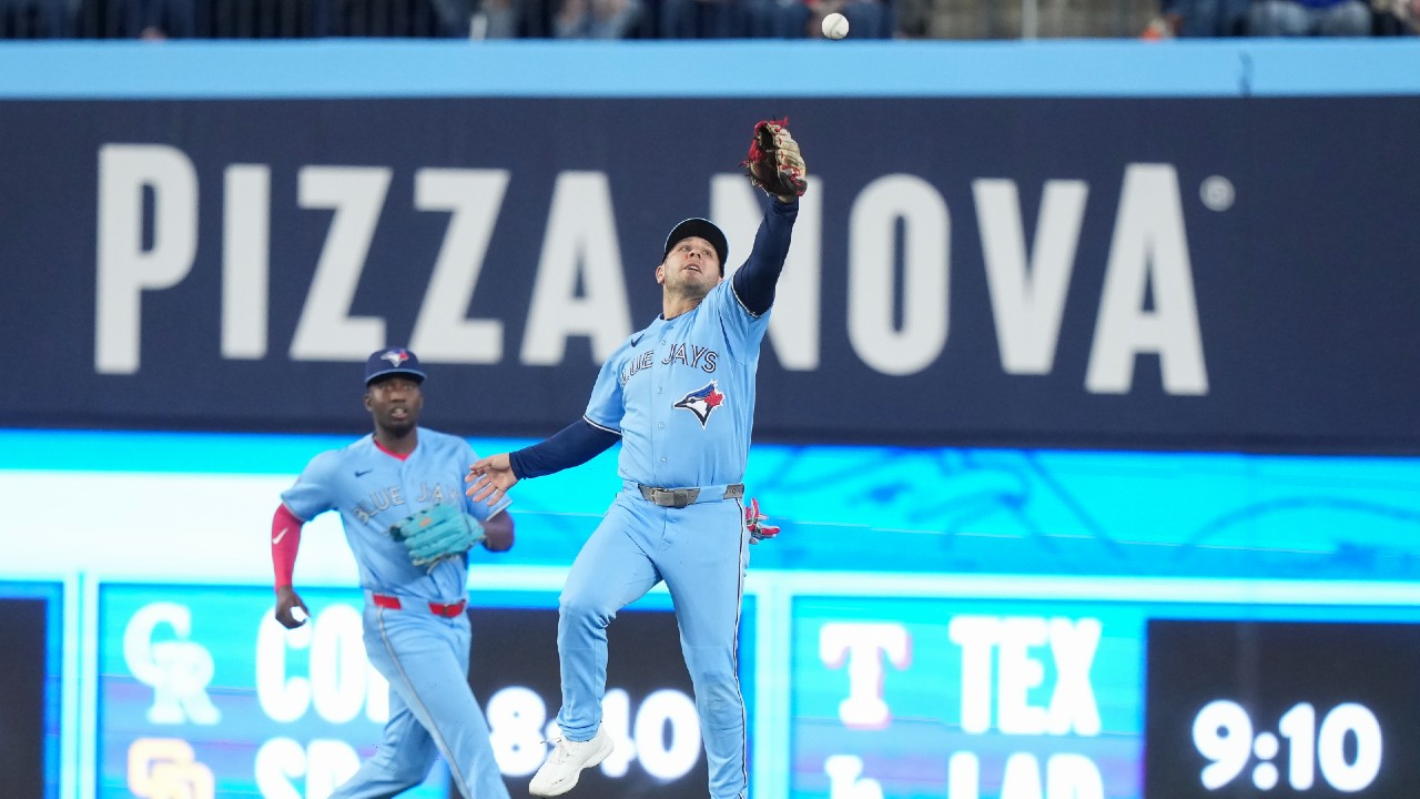 Toronto Blue Jays outfielder Daulton Varsho (5) misses a ball as teammate Jesus Sanchez (12) looks on
