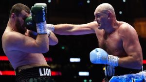 Boxer Tyson Fury, right, punches Arslanbek Makhmudov during a heavyweight bout at Tottenham Hotspur Stadium in London, Saturday, April 11, 2026. (Bradley Collyer/PA via AP)