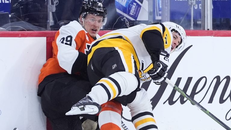 Pittsburgh Penguins' Sidney Crosby, right, collides with Philadelphia Flyers' Matvei Michkov during the second period of an NHL hockey game Monday, Dec. 1, 2025, in Philadelphia. (AP Photo/Matt Slocum)