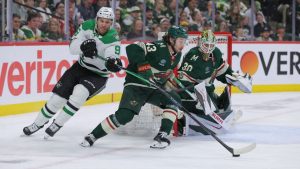Minnesota Wild defenceman Quinn Hughes skates with the puck in front of Jesper Wallstedt (30) while Dallas Stars right winger Mikko Rantanen defends during the second period of Game 6 in the first round of the Stanley Cup Playoffs Thursday, April 30, 2026, in St. Paul, Minn. (AP Photo/Bailey Hillesheim)