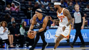 Orlando Magic guard Jalen Suggs (4) drives against Atlanta Hawks guard Nickeil Alexander-Walker (7) during the second half of an NBA basketball game Wednesday, April 1, 2026, in Orlando, Fla. (AP Photo/Kevin Kolczynski)