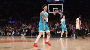 Charlotte Hornets' LaMelo Ball, center, reacts after scoring during the first half of an NBA basketball game against the New York Knicks, Sunday, April 12, 2026, in New York. (AP Photo/Pamela Smith)