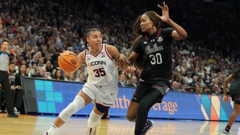 UConn guard Azzi Fudd (35) drives against South Carolina forward Maryam Dauda (30) during the first half of a woman's NCAA college basketball tournament semifinal game at the Final Four, Friday, April 3, 2026, in Phoenix. (AP Photo/Rick Scuteri)
