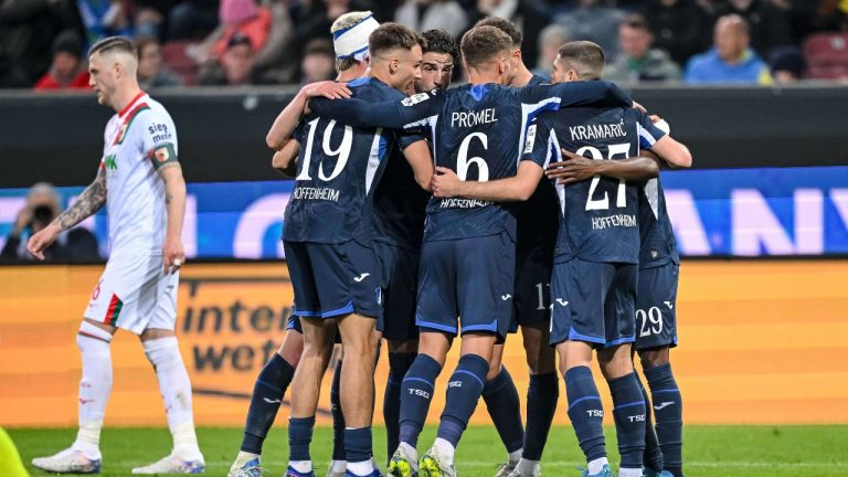 Hoffenheim's Bazoumana Toure celebrates with teammates after scoring during the German Bundesliga soccer match between FC Augsburg and TSG 1899 Hoffenheim in Augsburg, Germany, Friday, April 10, 2026. (Harry Langer/dpa via AP)