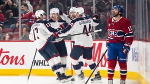 Columbus Blue Jackets' Mason Marchment (17), Danton Heinen (43), Erik Gudbranson (44) and Charlie Coyle (3) celebrate a goal while Montreal Canadiens' Alex Newhook (15) looks on, during first period NHL hockey action in Montreal on Saturday, April 11, 2026. (Christopher Katsarov/CP)
