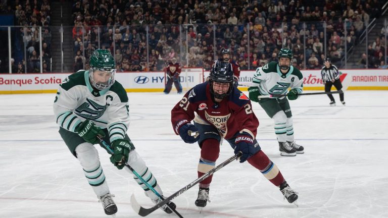 Boston Fleet's Megan Keller (5) skates in to take the puck from Montreal Victoire's Maureen Murphy (21) during second period PWHL hockey action in Laval, Quebec on Sunday March 15, 2026. (CP/Peter McCabe)