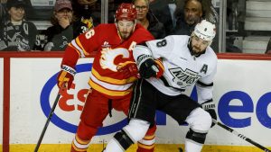 Los Angeles Kings' Drew Doughty, right, checks Calgary Flames' Joel Farabee during third period NHL hockey action in Calgary on Tuesday, March 24, 2026.THE CANADIAN PRESS/Jeff McIntosh