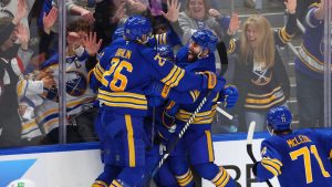 Buffalo Sabres players celebrate a goal by defenceman Mattias Samuelsson (23) during the third period in Game 1 of a first-round Stanley Cup playoff series against the Boston Bruins, Sunday, April 19, 2026, in Buffalo, N.Y. (AP Photo/Jeffrey T. Barnes)
