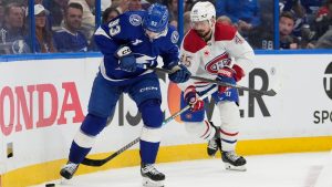 Tampa Bay Lightning centre Gage Goncalves and Montreal Canadiens defenceman Alexandre Carrier battle for a loose puck during the first period in Game 1 of a Stanley Cup first-round playoff series, Sunday, April 19, 2026, in Tampa, Fla. (AP Photo/Chris O'Meara)