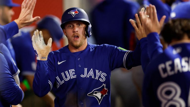 Toronto Blue Jays' Myles Straw is greeted by teammates after scoring during the seventh inning of a game against the Los Angeles Angels, Monday, April 20, 2026, in Anaheim, Calif. (AP Photo/Caroline Brehman)