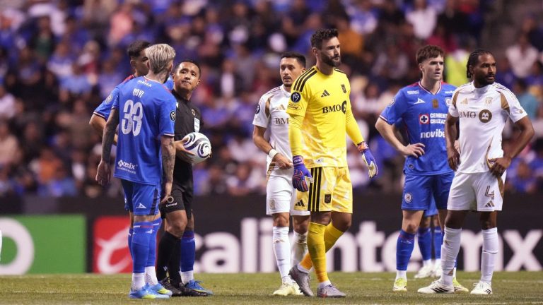 Referee Ivan Barton, second from left, suspends the match due to discriminatory chants from the crowd during a Concacaf Champions Cup quarterfinal second leg match between Mexico's Cruz Azul and the United States' Los Angeles FC in Puebla, Mexico, Tuesday, April 14, 2026. (AP Photo/Eduardo Verdugo)